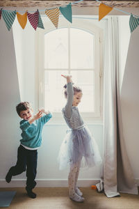 Girl and boy playing at home