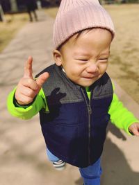 Close-up of cute baby boy walking on road