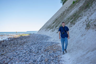 Full length of man on beach against sky