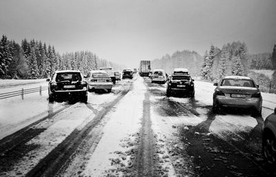 Cars on road against sky during winter