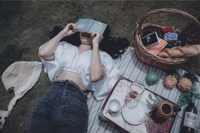 High angle view of woman reading book