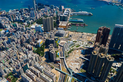 Aerial view of city by sea against sky