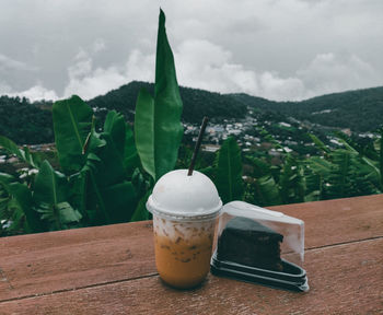 Close-up of drink on table against sky