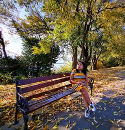 Portrait of young woman sitting on bench