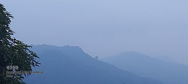 Scenic view of snowcapped mountains against clear blue sky