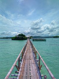 Pier over sea against sky