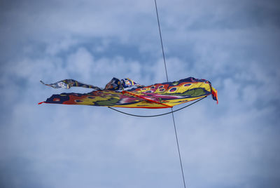 Low angle view of flags hanging against sky