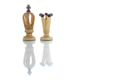 Close-up of chess pieces against white background