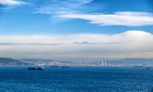 Sailboats in sea against sky