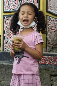 Portrait of a smiling girl holding ice cream