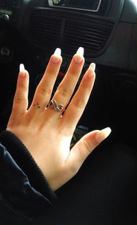 Close-up of woman hand in car