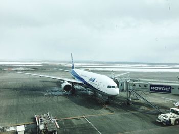 Airplane on sea against sky