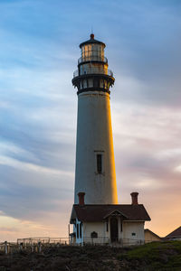 Low angle view of lighthouse against sky during sunset