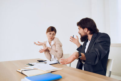 Business people discussing with papers on table