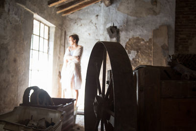 Woman sitting on chair by window