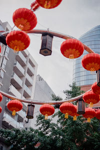 Low angle view of lanterns hanging against sky