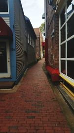 Red road amidst buildings in city