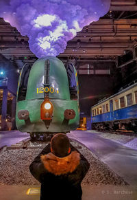 Train on railroad tracks amidst buildings against sky