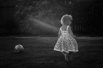 Young girl playing in grass
