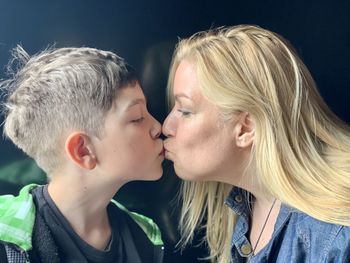 Portrait of  mother and son kissing