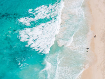 High angle view of waves splashing on beach