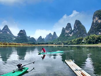 People in boat against sky