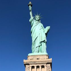 Statue of liberty against blue sky