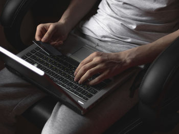 Midsection of woman using laptop
