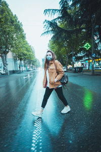 Woman with umbrella on street in city