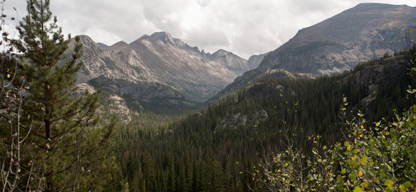 Scenic view of mountains against cloudy sky