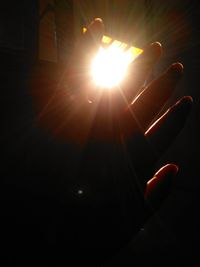 Close-up of hand against bright sun