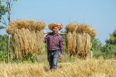 Full length of man wearing hat standing on field