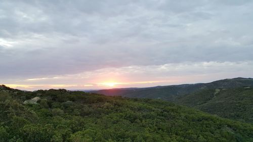 Scenic view of field against sky during sunset