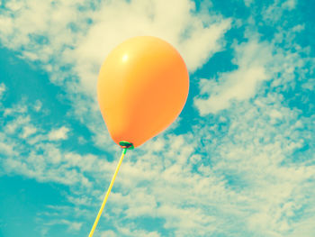 Low angle view of balloons against sky