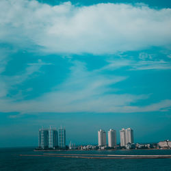 Sea and buildings against sky