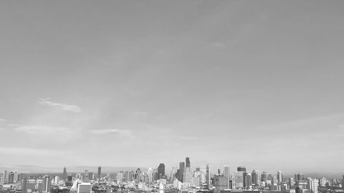 View of cityscape against cloudy sky