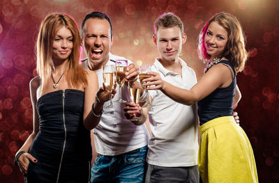 Friends holding champagne flutes at party