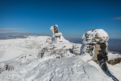 Scenic view of snowcapped landscape against blue sky