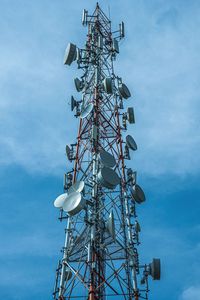 Low angle view of communications tower against sky