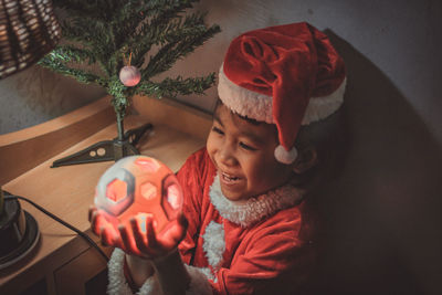 Midsection of man with christmas tree