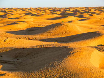 Scenic view of desert land against sky