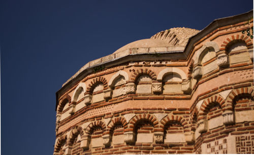 Low angle view of historic building against clear blue sky