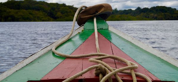 Boat in lake against mountain and sky