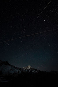 Low angle view of mountain against sky at night