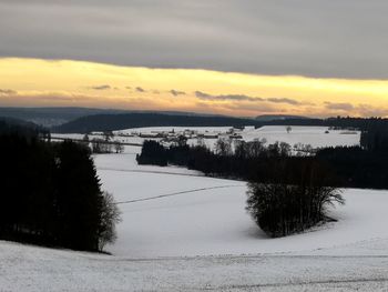 Scenic view of landscape against sky during winter