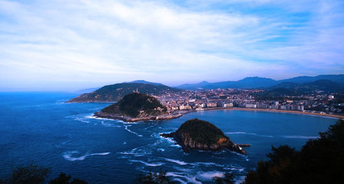 High angle view of sea and city against sky