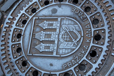 Prazska kanalizace manhole cover featuring a prague coat of arms and the bridge tower