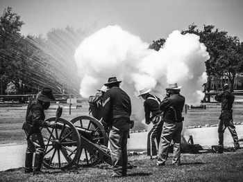 Full length on men standing by smoke at war