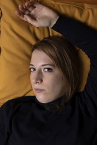 Portrait of woman lying on bed