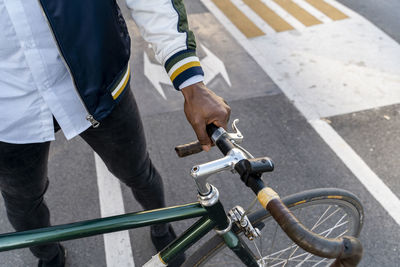 Close-up of casual businessman with bicycle in the city